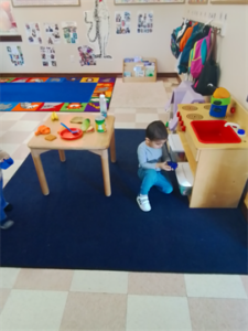 Toddler: Cooking carefully in the home center