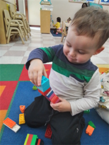 Toddler: Creating a Lego tower while building fine motor skills and hand-eye coordination