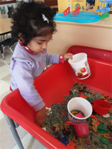 Exploring rice and pasta in the sensory table